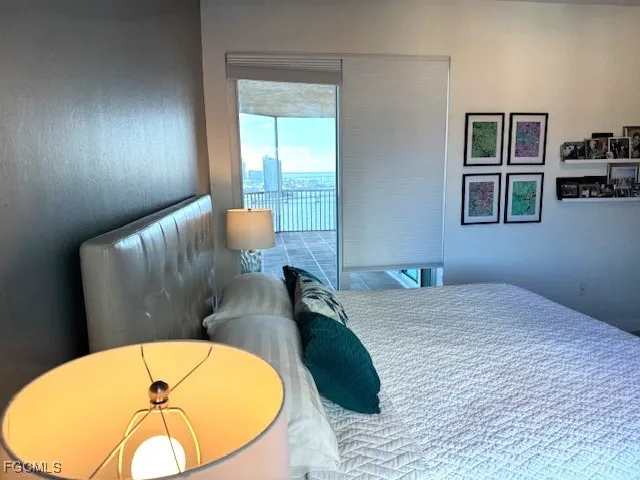 a living room with furniture and floor to ceiling window