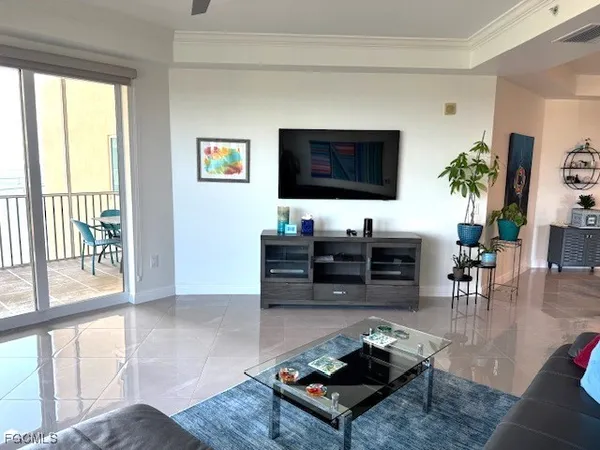 a view of a balcony chairs and floor to ceiling window