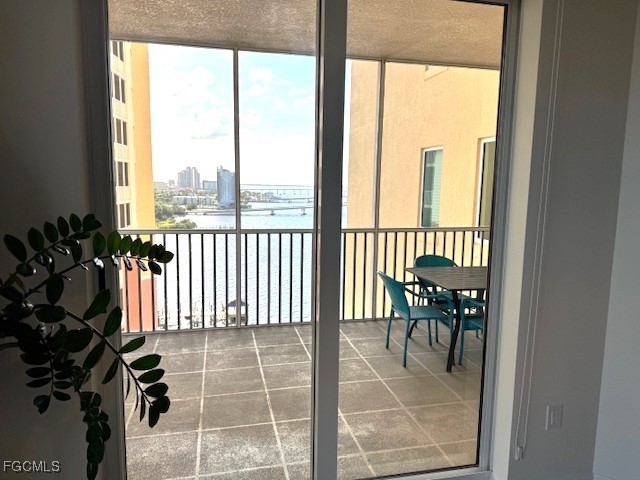 2745 First Street, Unit 1305 Fort Myers, FL 33916 - Photo 20 of 36 a view of a balcony chairs and floor to ceiling window