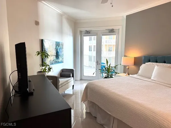 a bedroom with a bed and dresser next to a window