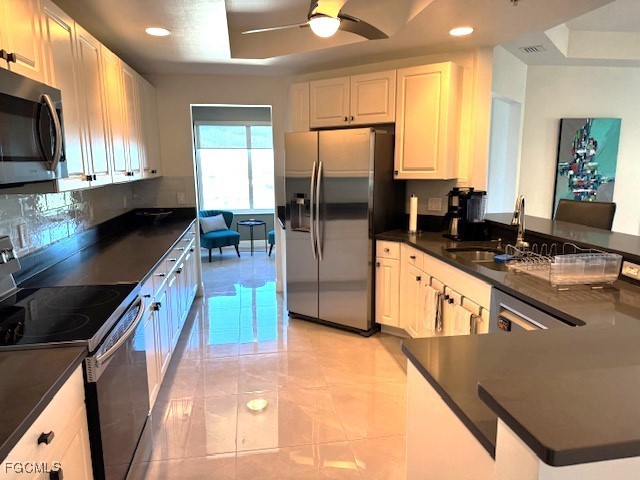 2745 First Street, Unit 1305 Fort Myers, FL 33916 - Photo 6 of 36 a kitchen with stainless steel appliances granite countertop a stove a sink and a microwave