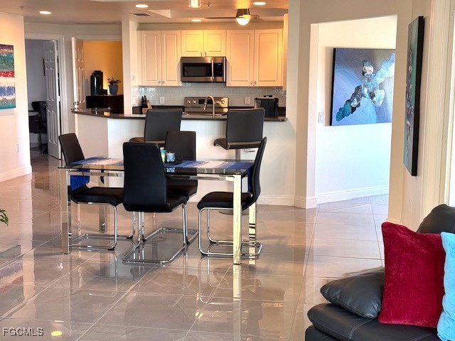 2745 First Street, Unit 1305 Fort Myers, FL 33916 - Photo 9 of 36 a kitchen with stainless steel appliances kitchen island granite countertop a refrigerator and microwave