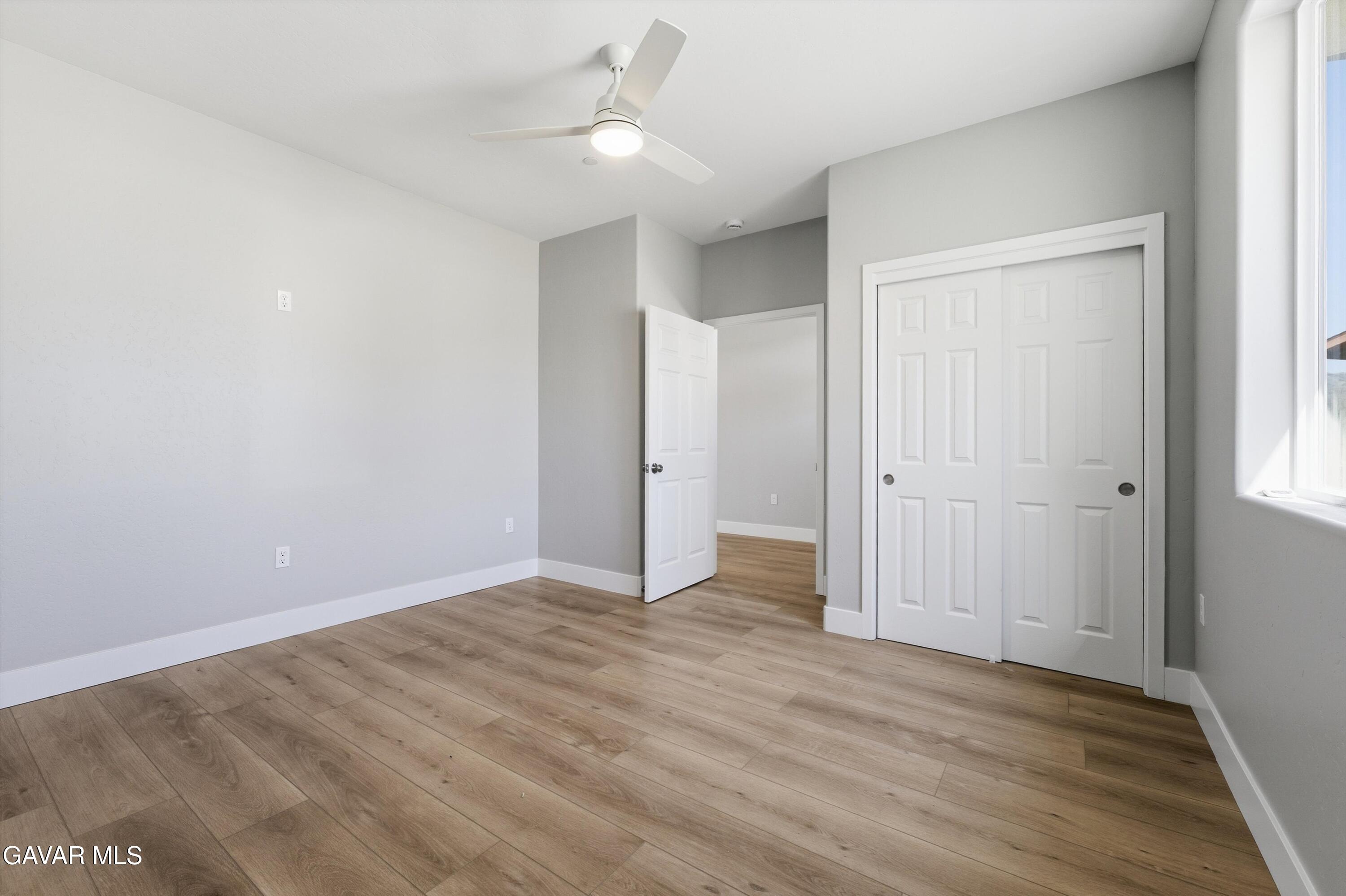 22613 Royal Place Tehachapi, CA 93561 - Photo 12 of 28 a view of an empty room with wooden floor