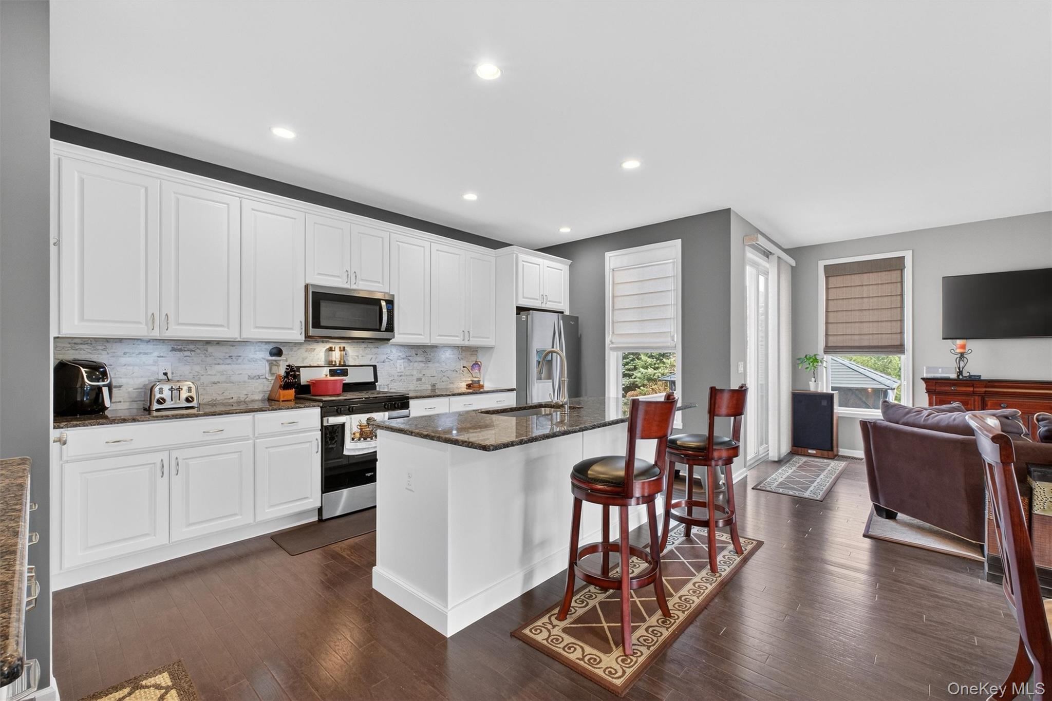 25 Hoffman Road Hopewell Junction, NY 12533 - Photo 4 of 35 a kitchen with white cabinets and stainless steel appliances