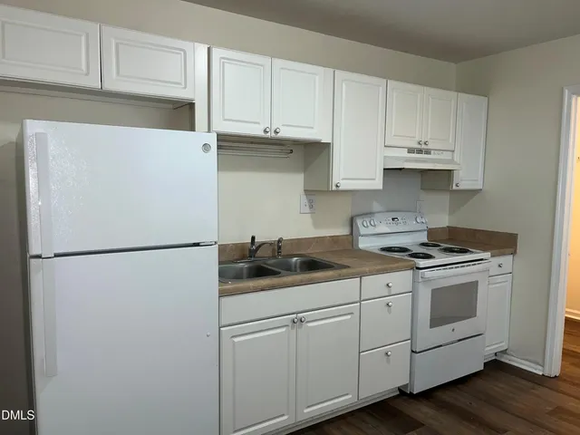 a white refrigerator freezer sitting inside of a kitchen