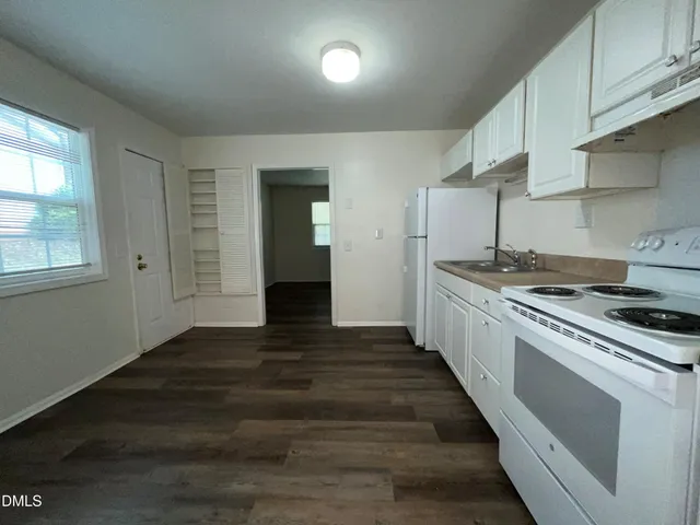 a kitchen with granite countertop a stove and a sink