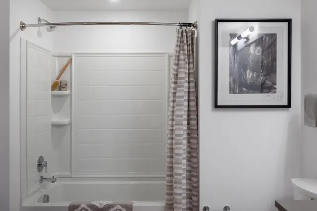 a bathroom with a shower and a sink