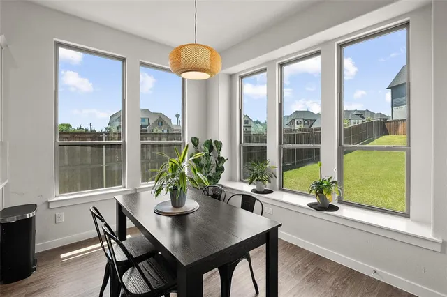 a dining room with furniture a chandelier and wooden floor