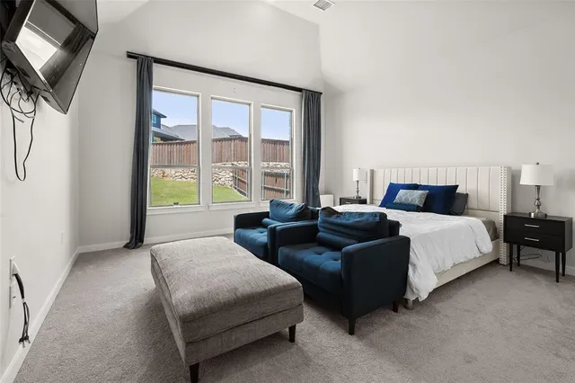 a bedroom with two beds and a large window