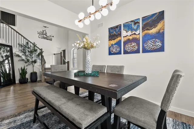 a view of a dining room with furniture and a chandelier