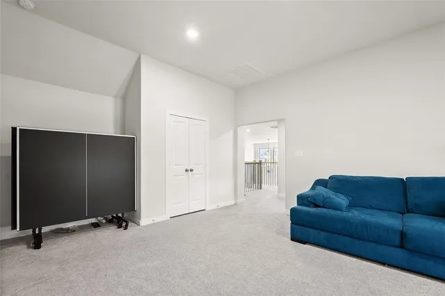 a living room with furniture and a air conditioner vent