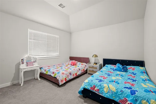 a bedroom that has two beds and a dresser