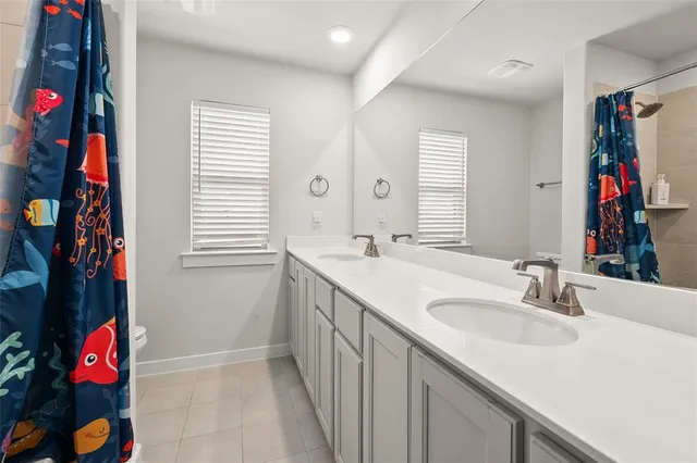 a bathroom with a sink vanity and a mirror