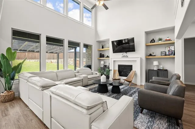 a living room with furniture a flat screen tv and a fireplace