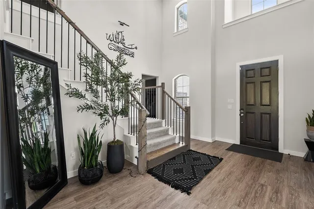 a view of entryway and hall with wooden floor