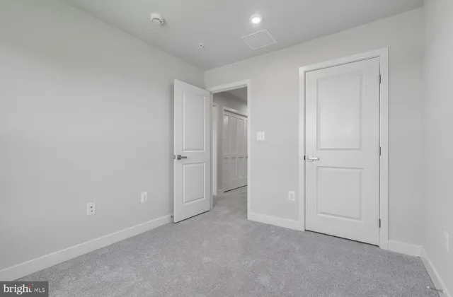 an empty room with closet area