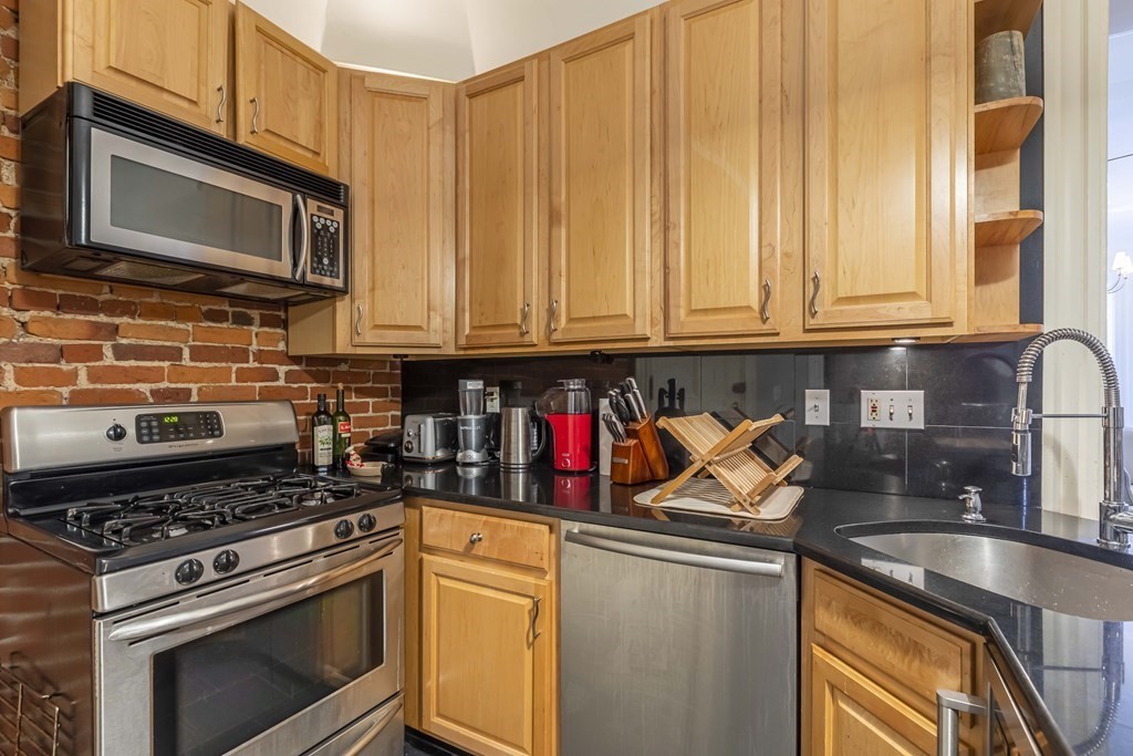 362 Commonwealth Avenue, Unit 2A Boston, MA 02115 - Photo 12 of 38 a kitchen with stainless steel appliances granite countertop a stove and a microwave