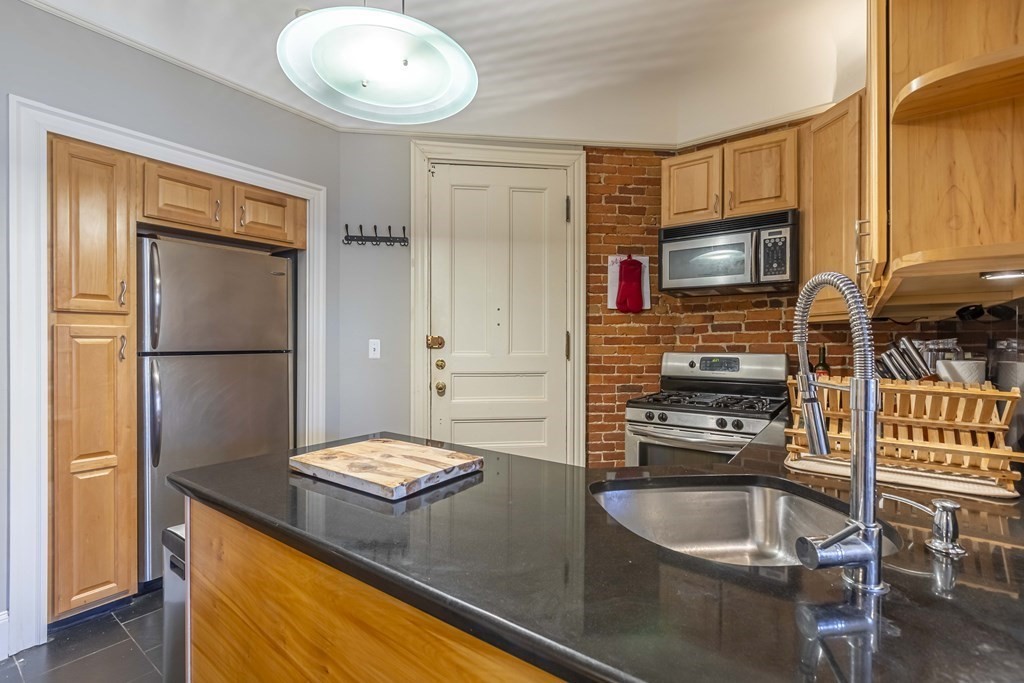 362 Commonwealth Avenue, Unit 2A Boston, MA 02115 - Photo 14 of 38 a kitchen with a refrigerator a stove and a sink