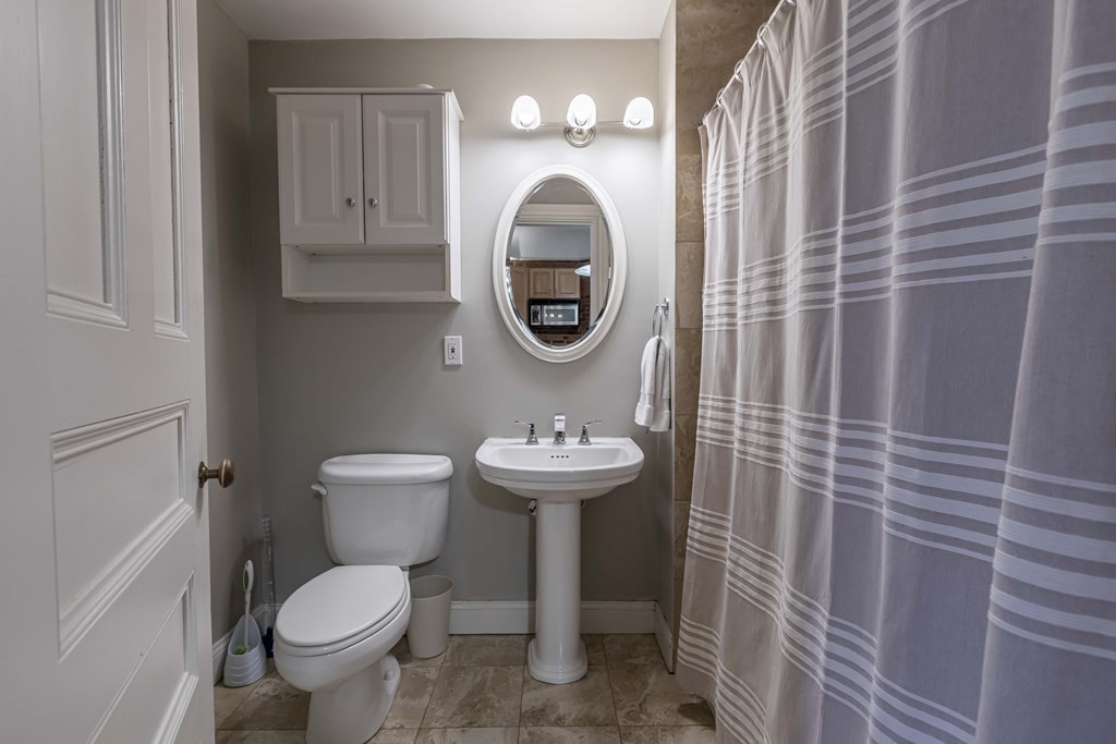 362 Commonwealth Avenue, Unit 2A Boston, MA 02115 - Photo 18 of 38 a bathroom with a sink a toilet and a mirror