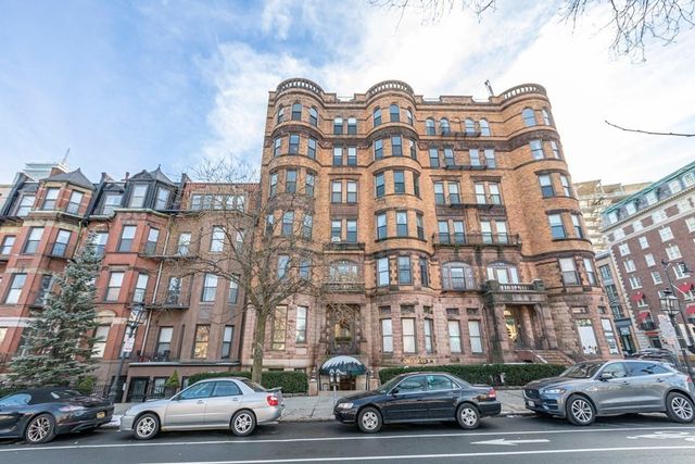 a view of a car parked in front of a buildings