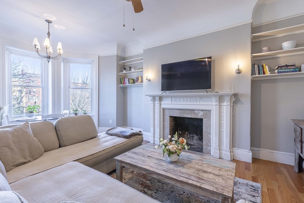 362 Commonwealth Avenue, Unit 2A Boston, MA 02115 - Photo 8 of 38 a living room with furniture and a fireplace