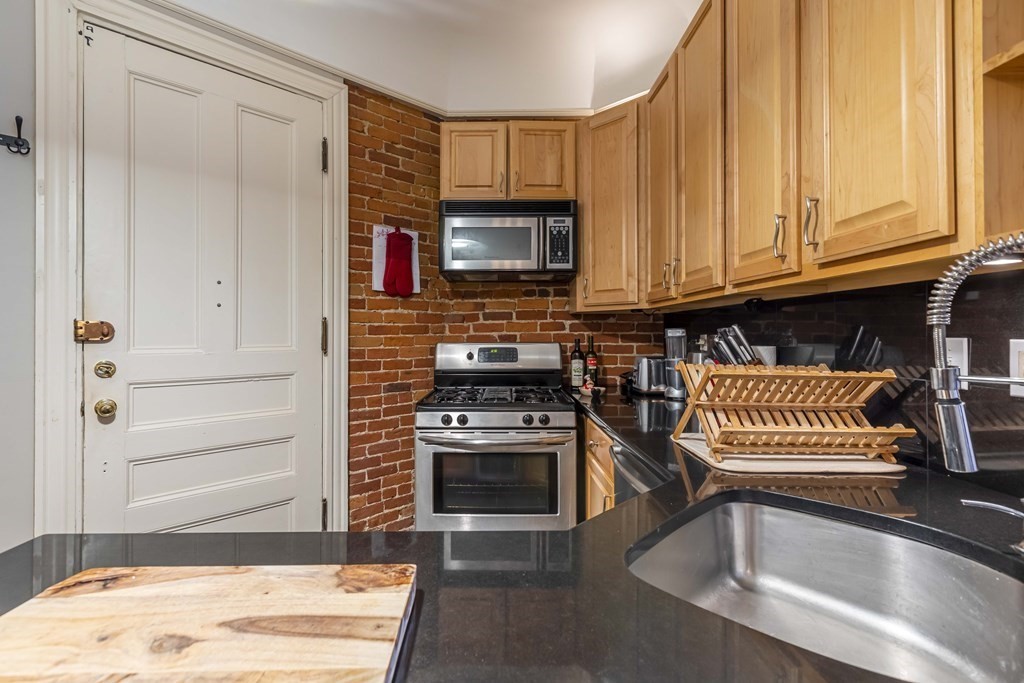 362 Commonwealth Avenue, Unit 2A Boston, MA 02115 - Photo 10 of 38 a kitchen with granite countertop a stove and a sink