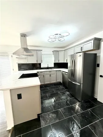 a kitchen with a stove a refrigerator and cabinets