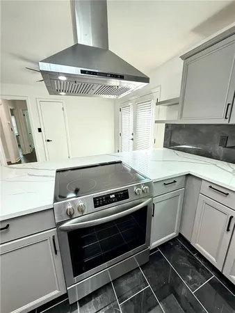 a kitchen with granite countertop a stove and a sink