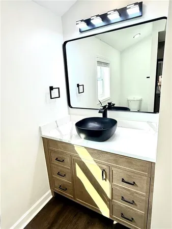 a bathroom with a sink a mirror and vanity