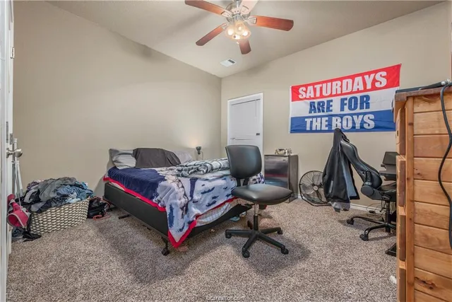 a bathroom with a granite countertop sink toilet and mirror