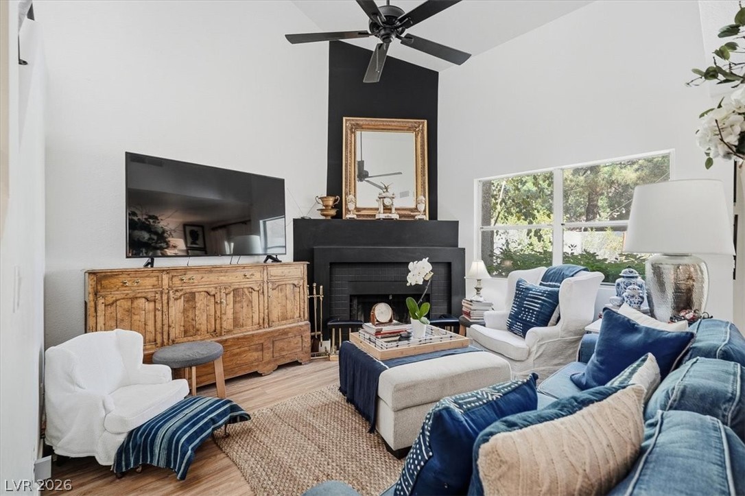 6250 West Flamingo Road, Unit 93 Las Vegas, NV 89103 - Photo 2 of 38 This inviting living room showcases a fireplace and elegant hardwood flooring, perfect for cozy gatherings.