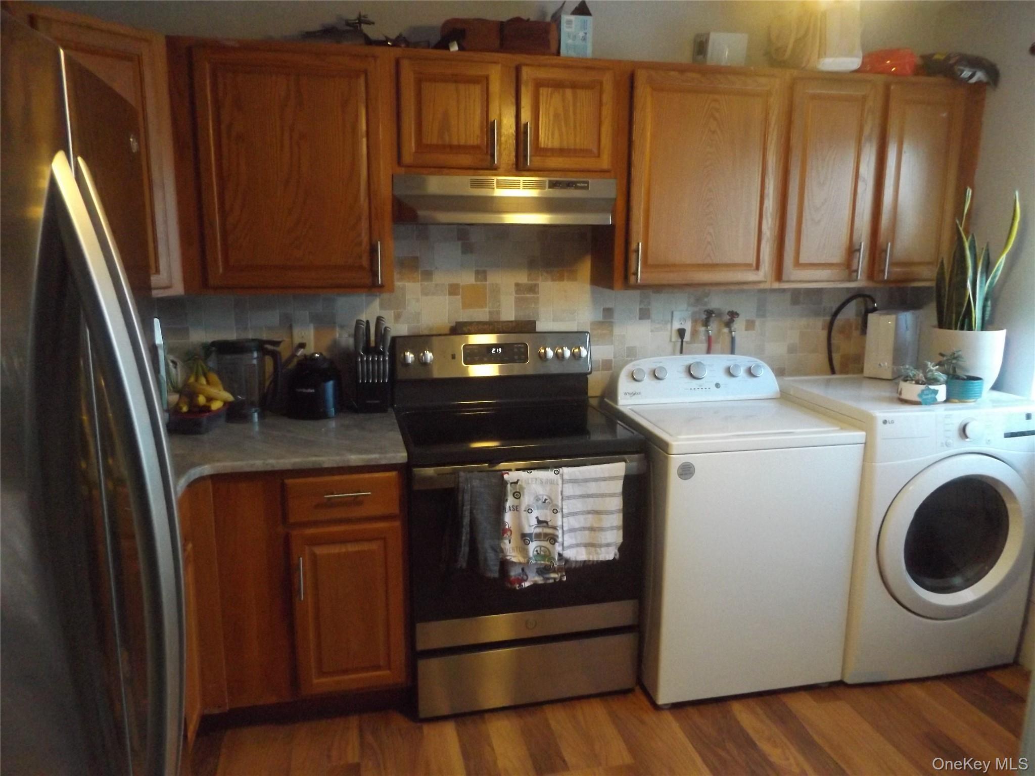 5 Millholland Drive, Unit F Fishkill, NY 12524 - Photo 4 of 13 a kitchen with stainless steel appliances granite countertop a sink stove and cabinets