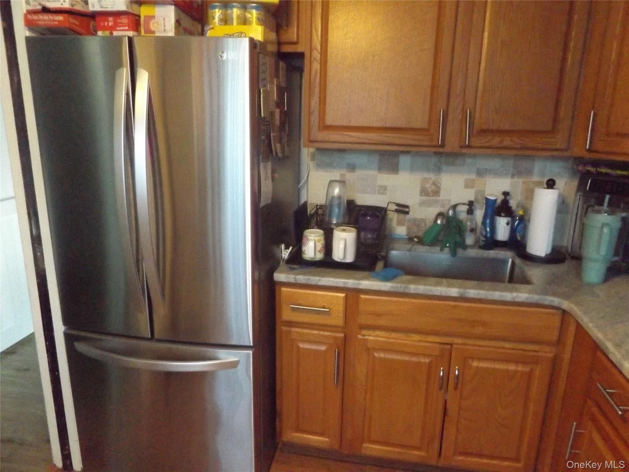 5 Millholland Drive, Unit F Fishkill, NY 12524 - Photo 5 of 13 a kitchen with stainless steel appliances granite countertop a refrigerator and a sink