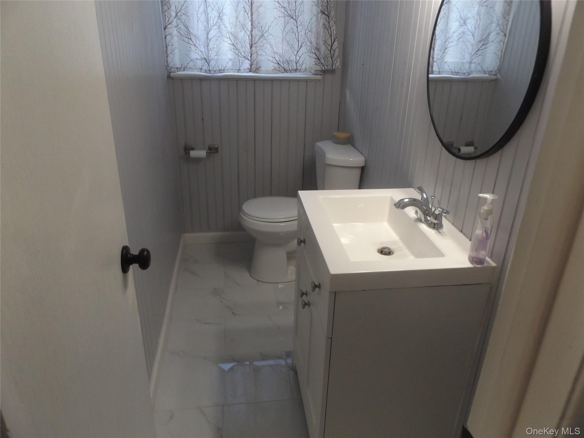 5 Millholland Drive, Unit F Fishkill, NY 12524 - Photo 6 of 13 a bathroom with a sink and mirror with toilet