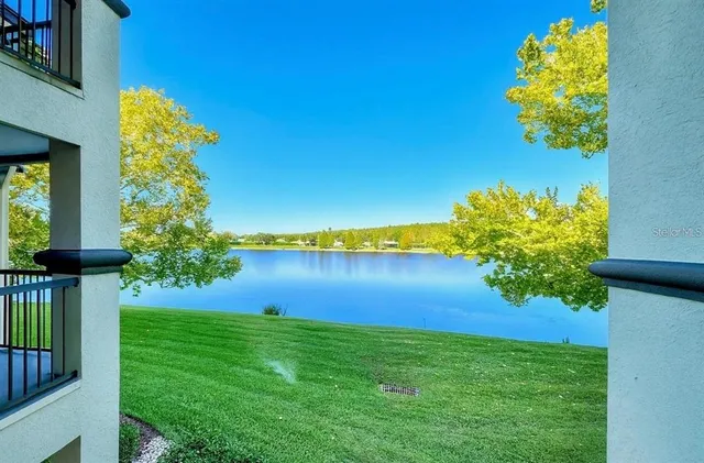 a view of a lake with a house in the background