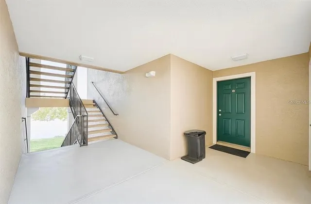 a view of an empty room with stairs and ventilation