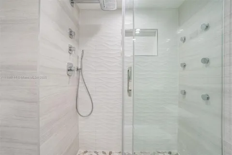 a bathroom with a glass shower door
