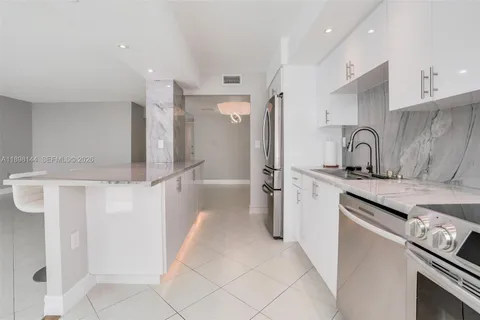 a kitchen with a refrigerator and a sink