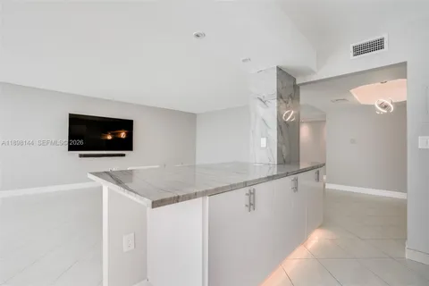 a kitchen with a sink and a mirror