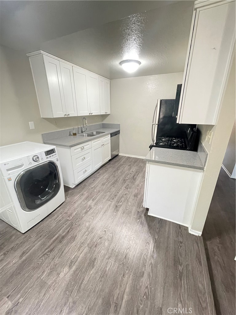 1000 Central Avenue, Unit 20 Riverside, CA 92507 - Photo 1 of 1 a kitchen with stainless steel appliances a stove a sink a microwave a refrigerator and cabinets