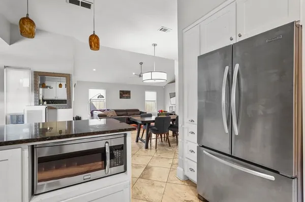 a kitchen with stainless steel appliances granite countertop a refrigerator and a stove