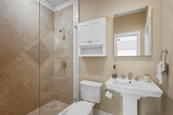 a bathroom with a sink toilet and shower