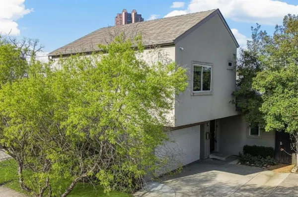 a house that has a tree in front of it