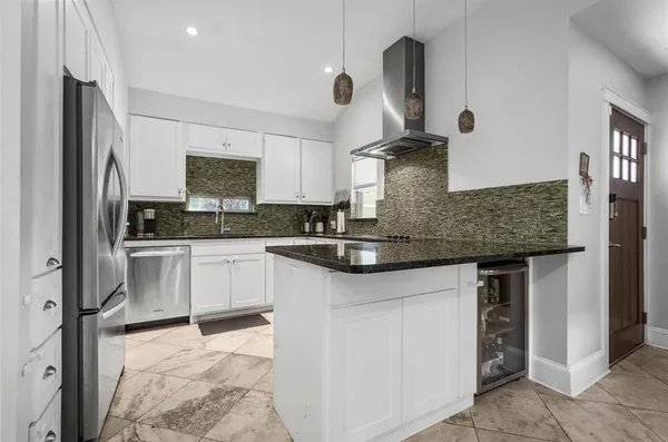 a kitchen with stainless steel appliances granite countertop a sink stove and refrigerator