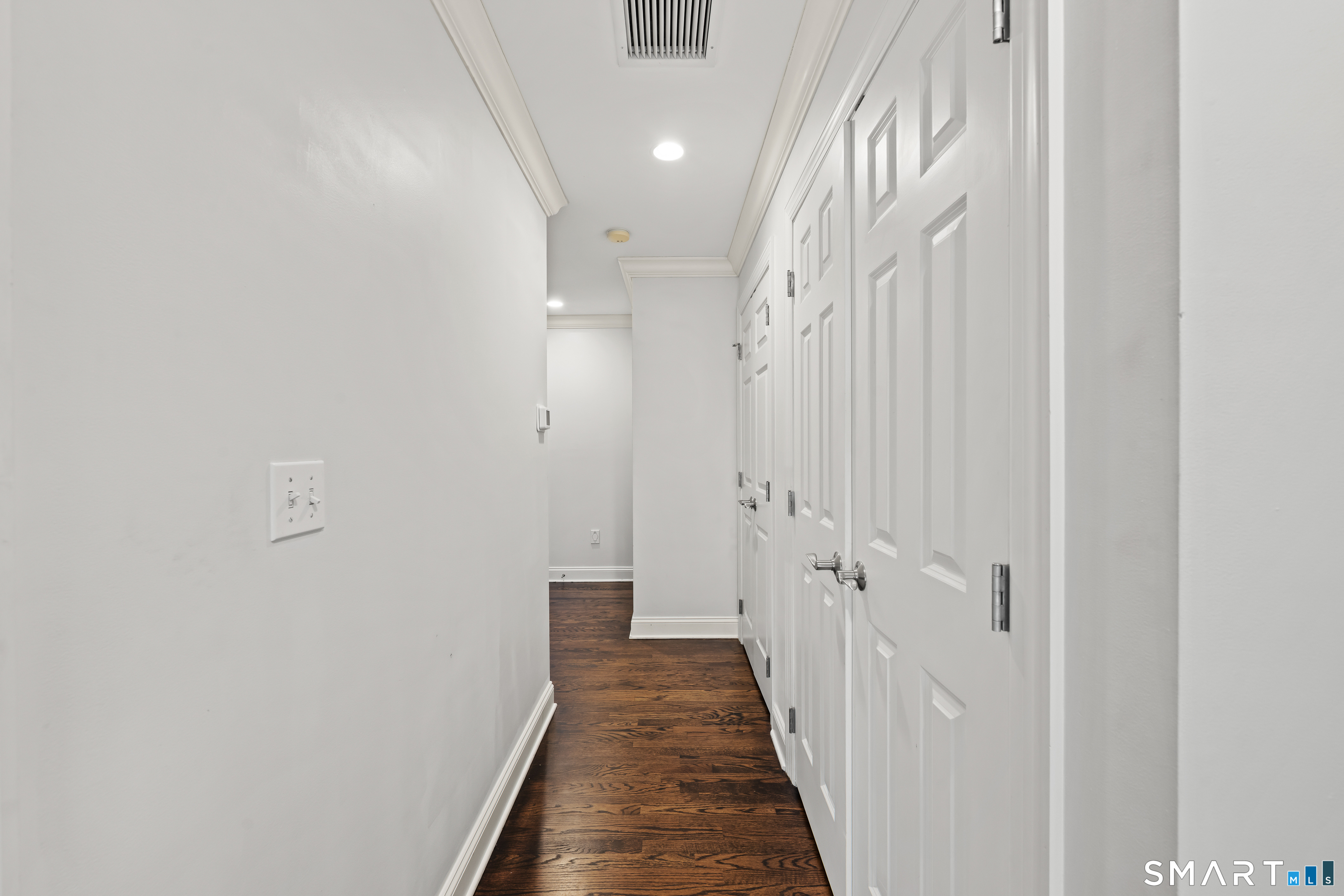 71 Aberdeen Way, Unit 71 Fairfield, CT 06890 - Photo 24 of 37 a view of a hallway with wooden floor and staircase