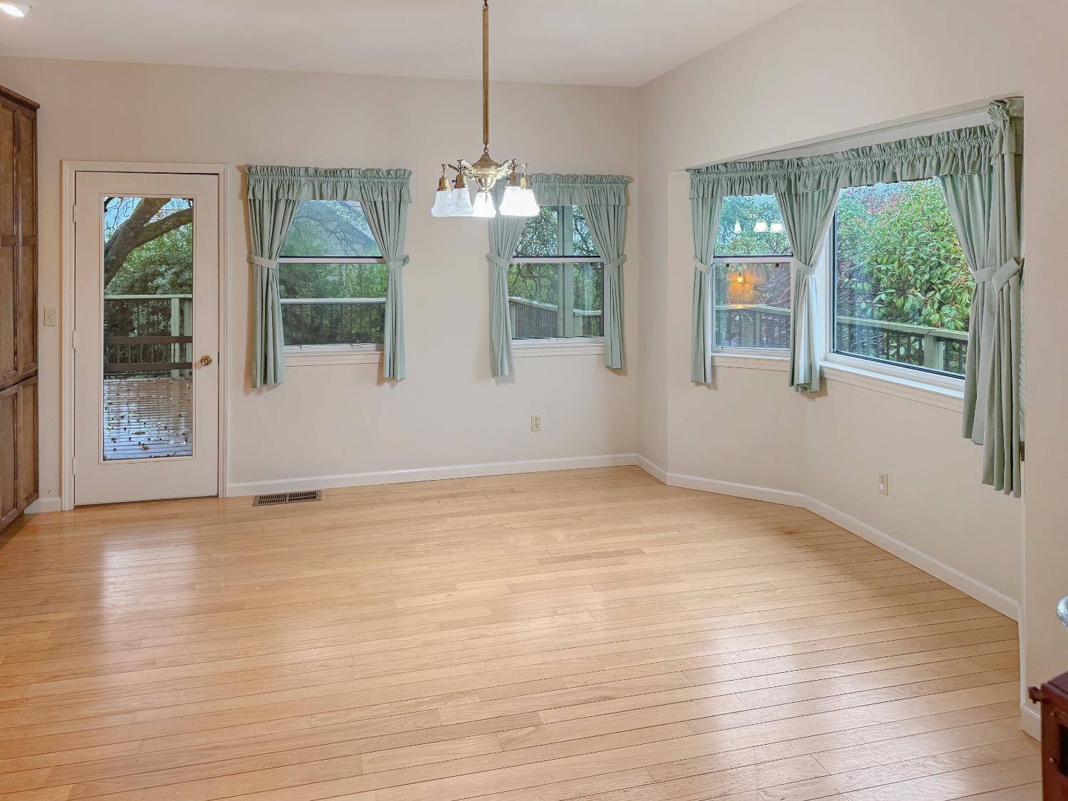 12439 Homestead Way Auburn, CA 95603 - Photo 11 of 27 a view of empty room with wooden floor and fan