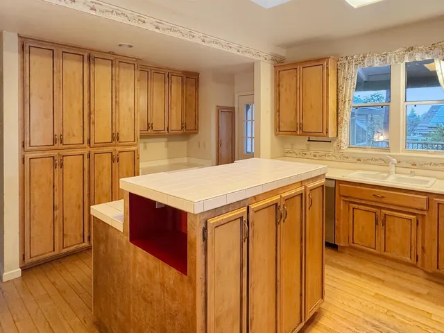 a kitchen with stainless steel appliances a refrigerator and wooden cabinets