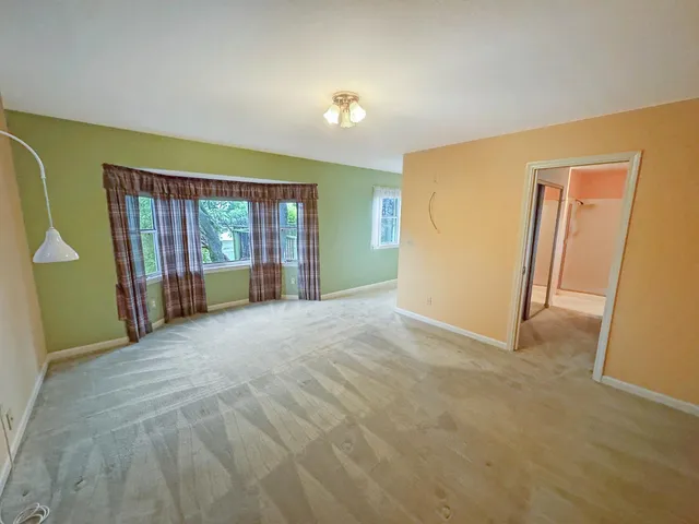 a view of an empty room with glass door