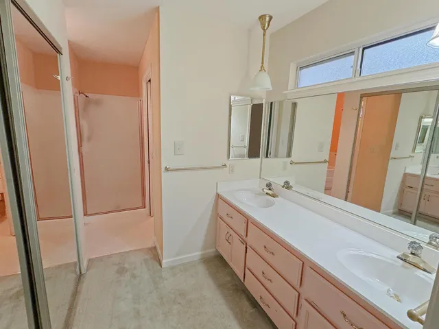 a bathroom with a double vanity sink a and mirror