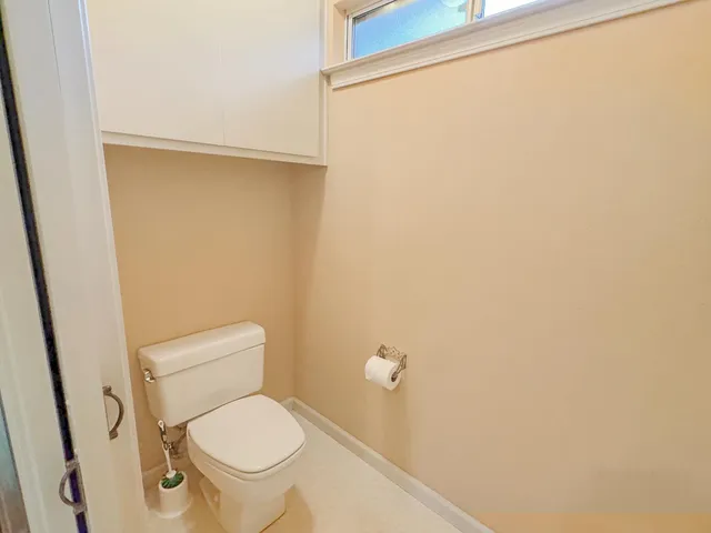 a white toilet sitting next to a shower